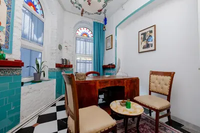 a room with a desk and a table and chairs at Nevalist Hotel in Istanbul