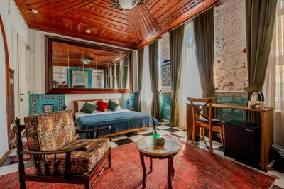 a bedroom with a bed and a couch and a table at Nevalist Hotel in Istanbul
