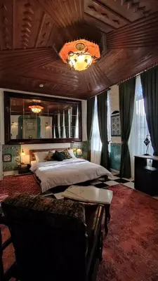 a large bedroom with a large bed and a ceiling at Nevalist Hotel in Istanbul