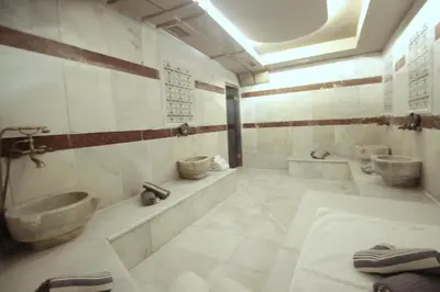 a bathroom with two sinks and two toilets at Villa Paradiso Hotel & Spa in Istanbul