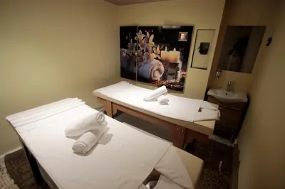 a bathroom with two beds and a sink with towels at Villa Paradiso Hotel & Spa in Istanbul