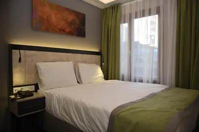 a bed in a hotel room with a window at BEST HOTEL KADIKOY in Istanbul