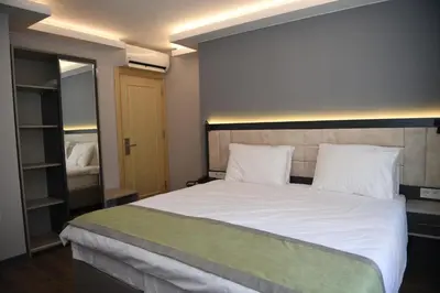 a bedroom with a large bed with white sheets and pillows at BEST HOTEL KADIKOY in Istanbul