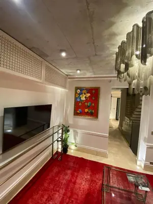 a lobby with a painting on the wall and a red carpet at AB Residences- Private Villa Independent in Istanbul