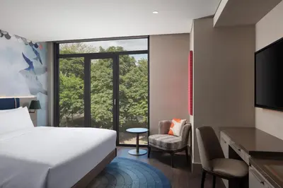 a hotel room with a bed and a large window at Lokalist, Istanbul, a Tribute Portfolio Hotel in Istanbul