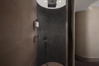 a bathroom with a shower with a toilet in it at Lokalist, Istanbul, a Tribute Portfolio Hotel in Istanbul