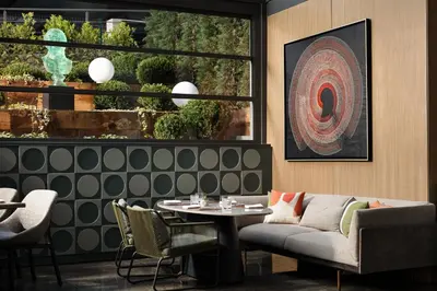 a living room with a couch and a table at Lokalist, Istanbul, a Tribute Portfolio Hotel in Istanbul