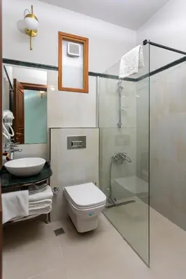 a bathroom with a shower and a toilet and a sink at Sirin Han Hotel Old City in Istanbul
