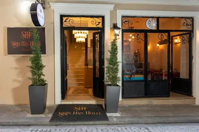 a store front with two potted plants in front of it at Sirin Han Hotel Old City in Istanbul