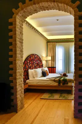 a bedroom with a bed with a brick wall at Sirin Han Hotel Old City in Istanbul