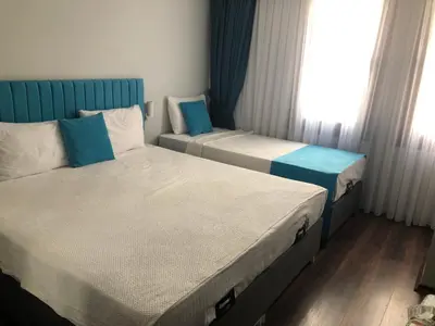 two twin beds in a room with a window at Nos Istanbul in Istanbul