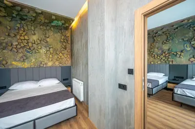 a bedroom with two beds and a painting on the wall at Continental Airport Hotel in Istanbul