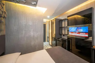 a bedroom with a bed and a flat screen tv at Continental Airport Hotel in Istanbul