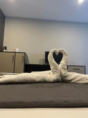 a towel shaped like a swan laying on a bed at Agora Royal Residence in Esenyurt