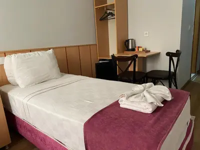 a hotel room with a bed with a towel on it at HOTEL ÖZSEFA in Istanbul