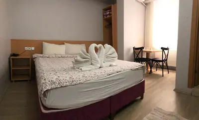 a bedroom with a bed with towels on it at HOTEL ÖZSEFA in Istanbul
