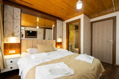 a bedroom with a large bed with white towels on it at Candy Boutıque in Istanbul