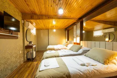 three beds in a room with wooden ceilings at Candy Boutıque in Istanbul
