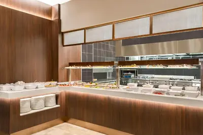 a restaurant with a buffet line with food at TRYP By Wyndham Istanbul Sisli Hotel in Istanbul