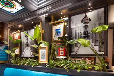 a room with plants and pictures on the wall at TRYP By Wyndham Istanbul Sisli Hotel in Istanbul