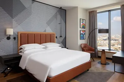 a bedroom with a large white bed and a desk at Sheraton Istanbul Esenyurt in Istanbul