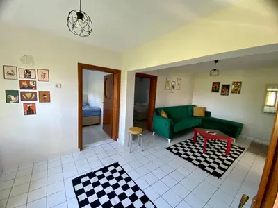 a living room with a green couch and a table at Maşukiye Home Suit Apart in Kartepe