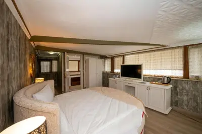 a bedroom with a bed and a tv in it at Fuat Bey Palace Hotel & Spa in Istanbul