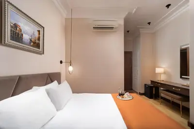 a hotel room with a white bed and a desk at Recital Park Hotel in Istanbul