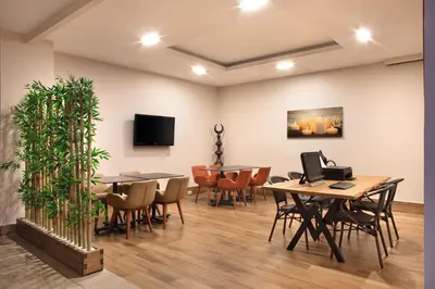 a waiting room with tables and chairs and a tv at Recital Park Hotel in Istanbul