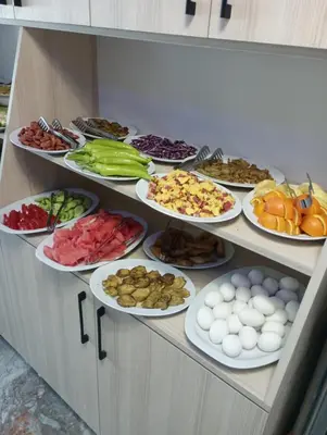 a buffet with many plates of food on a shelf at Bona Sera Hotel in Istanbul