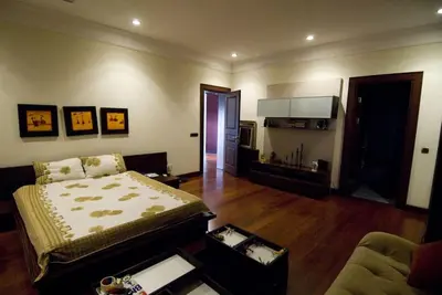 a bedroom with a bed and a living room at Silivri Gazitepe'de 3 katlı, havuzlu lüks villa in Silivri