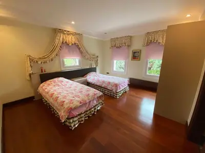 a bedroom with two beds and wooden floors and windows at Silivri Gazitepe'de 3 katlı, havuzlu lüks villa in Silivri