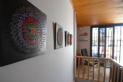 a hallway with three paintings on the wall at Duplex with terrace in center,5mn walk to Istiklal in Istanbul