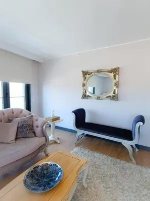 a living room with a couch and a mirror at Luxury Central Fully Equipped 3BR 2BA Apartment by Siena Suites in Istanbul