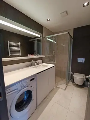 a bathroom with a washing machine and a sink at Luxury Fully Equipped 3BR 2BA Apartment by Siena Suites in Istanbul