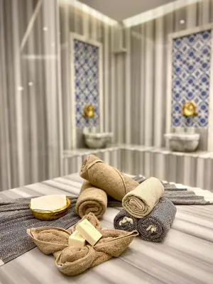 a bathroom with towels and cheese on a table at İncipark Hotel in Sakarya