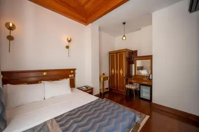 a bedroom with a large bed and a desk at Valeria Antique 1892 in Istanbul