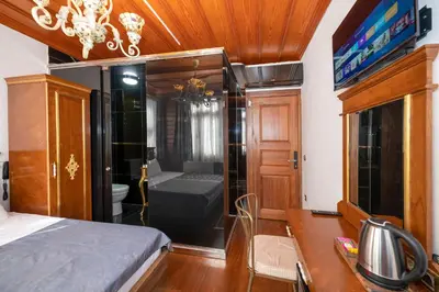 a bedroom with a bed and a bathroom with a shower at Valeria Antique 1892 in Istanbul