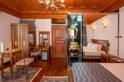 a bedroom with a bed and a table and a room at Valeria Antique 1892 in Istanbul