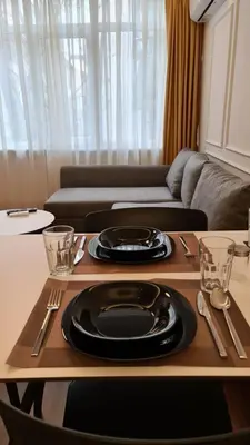 a table with a black plate on top of it at City Aparts Nisantasi in Istanbul