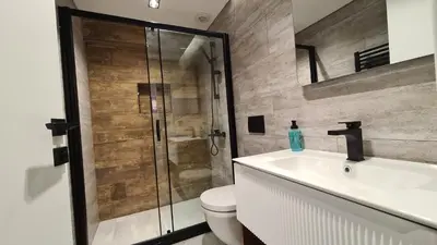 a bathroom with a shower and a toilet and a sink at City Aparts Nisantasi in Istanbul