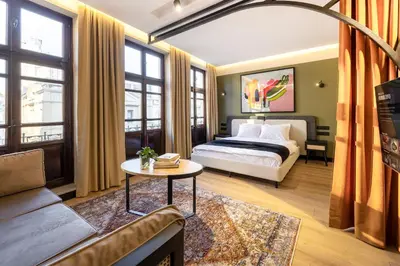 a bedroom with a bed and a couch and a table at Upside Apartments in Istanbul