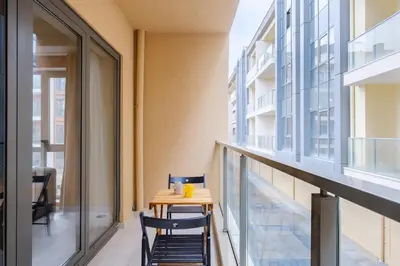 a balcony with a table and chairs next to a building at New Inn Hotel Cadde 54 Mall in Sakarya
