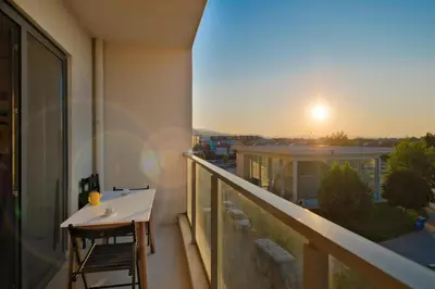 a balcony with a table and a view of a city at New Inn Hotel Cadde 54 Mall in Sakarya
