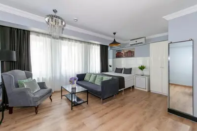 a living room with a bed and a couch and chairs at Lavanta Hotel in Istanbul