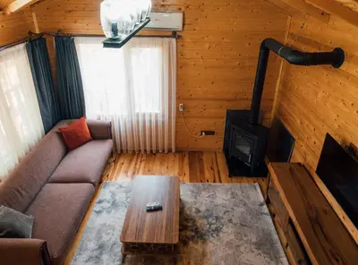 a living room with a couch and a stove at Sapanca Casamia Suit in Sapanca