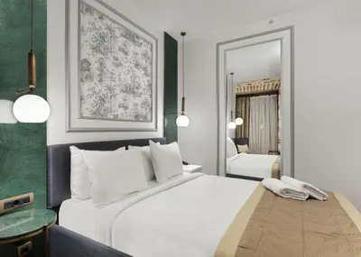 a bedroom with a white bed and a mirror at Pera Rasso Hotel in Istanbul
