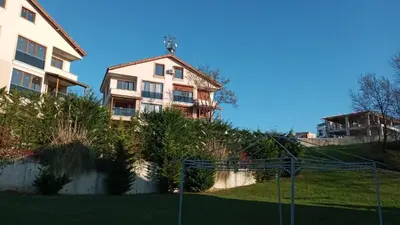 a apartment building with a basketball court in front at Sultan Villa, Merkez Mahallesi Dogu Sirti Caddesi Sultan Sitesi H-2 in Kadıköy