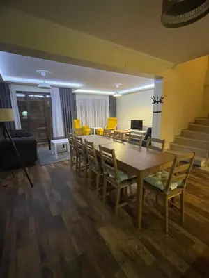 a dining room with a table and chairs at Sultan Villa, Merkez Mahallesi Dogu Sirti Caddesi Sultan Sitesi H-2 in Kadıköy