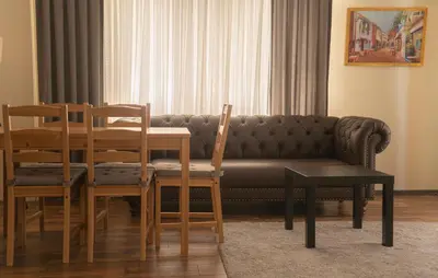 a living room with a couch and a table and chairs at Sultan Villa, Merkez Mahallesi Dogu Sirti Caddesi Sultan Sitesi H-2 in Kadıköy